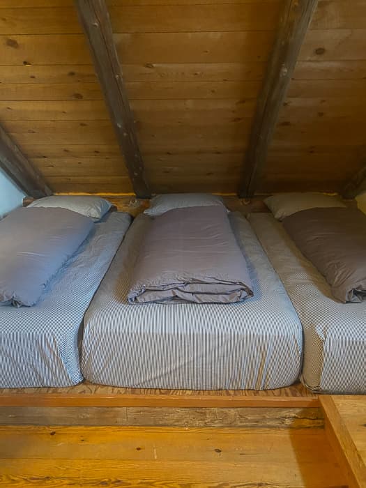 Three twin beds in the East 5-person room