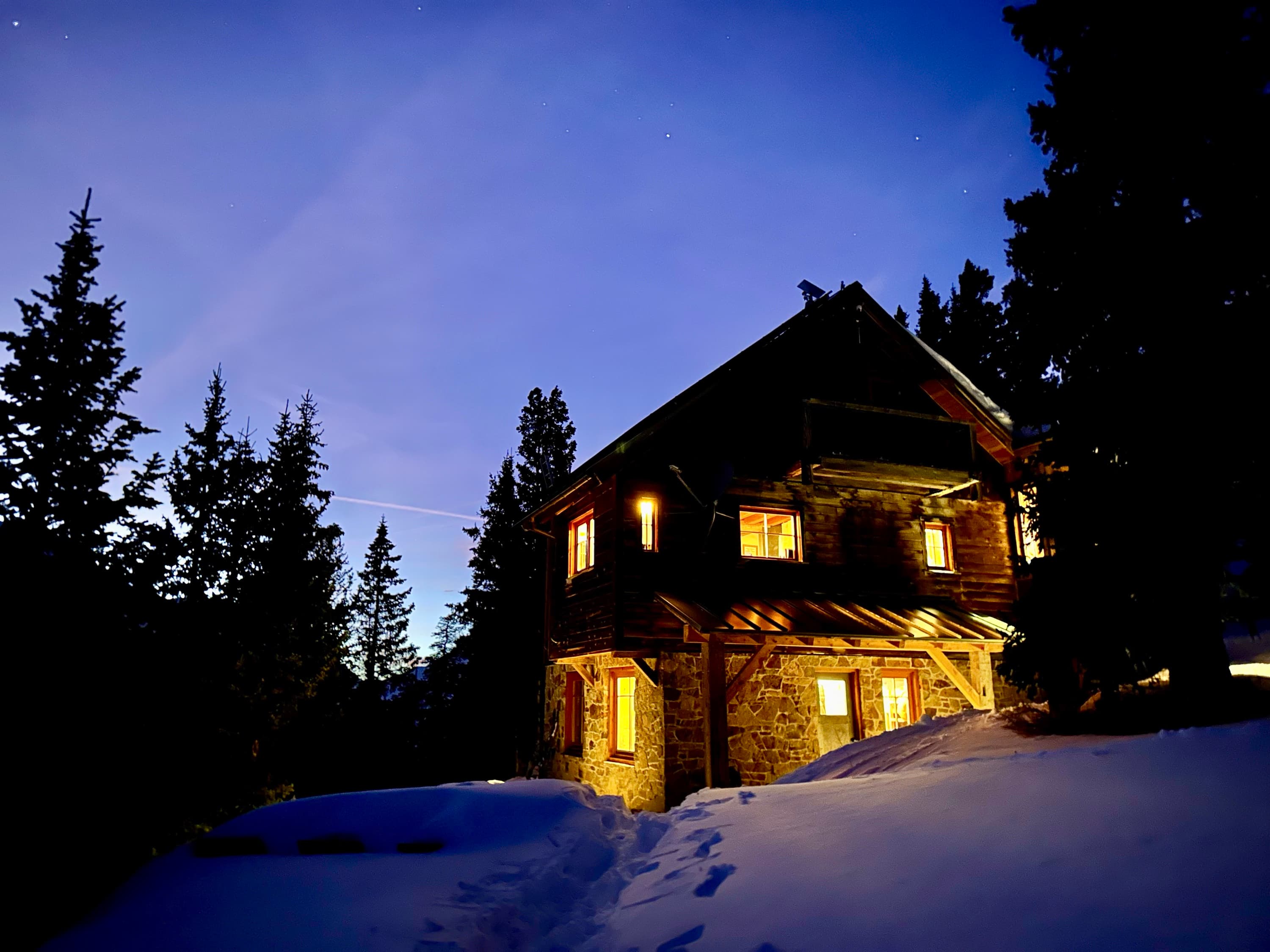 The whole hut glowing at winter dusk