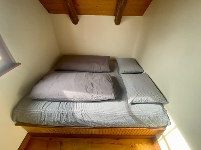The queen bed in the West 5-person room